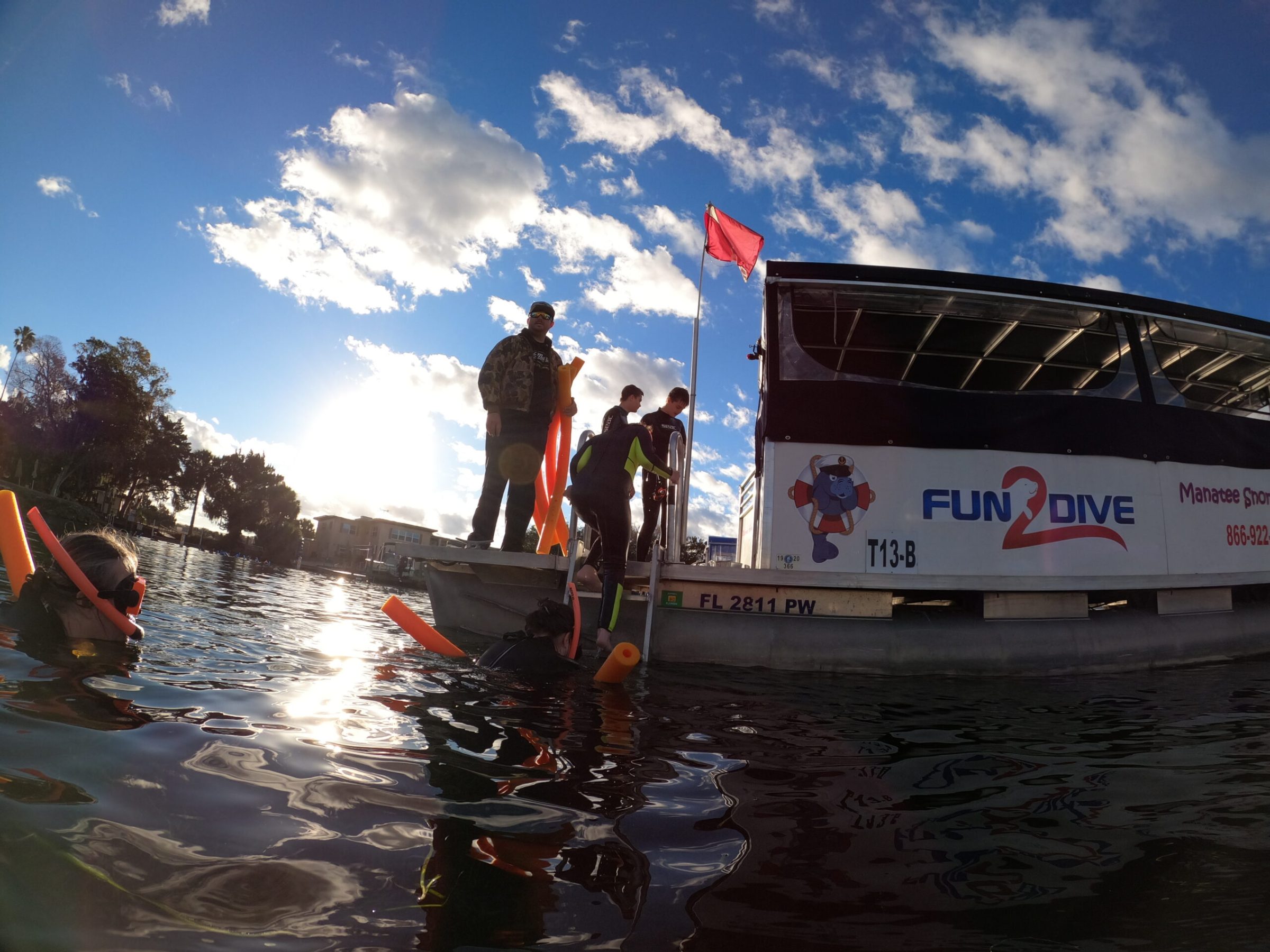 Group entering the water to swim with manatees.